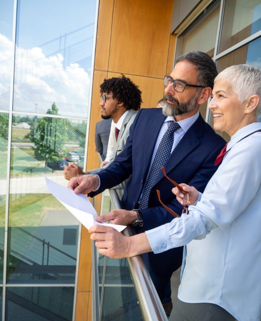 Successful happy business people are talking and smiling during the coffee break in office outdoor